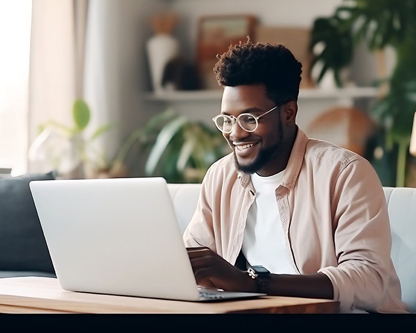 Black man using a laptop for online therapy in New York