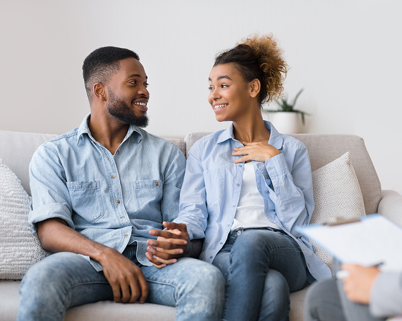 Couple sitting on a couch during couples therapy in New York